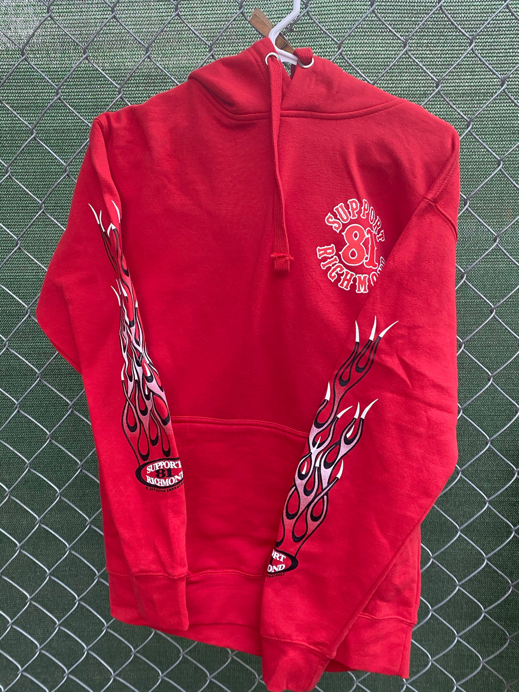 Red pullover hoodie with red and white flames on sleeves