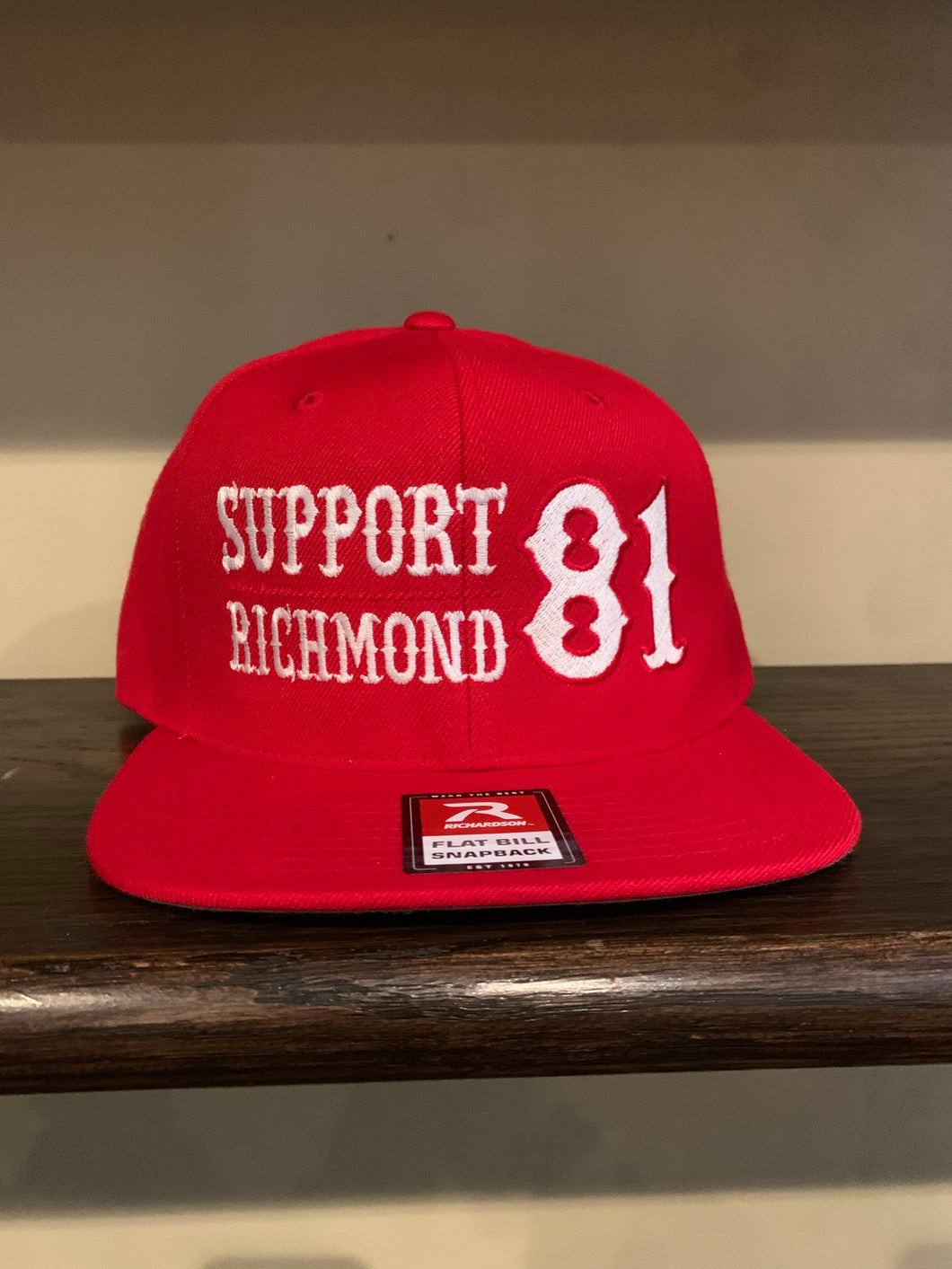 Red snap back with white writing